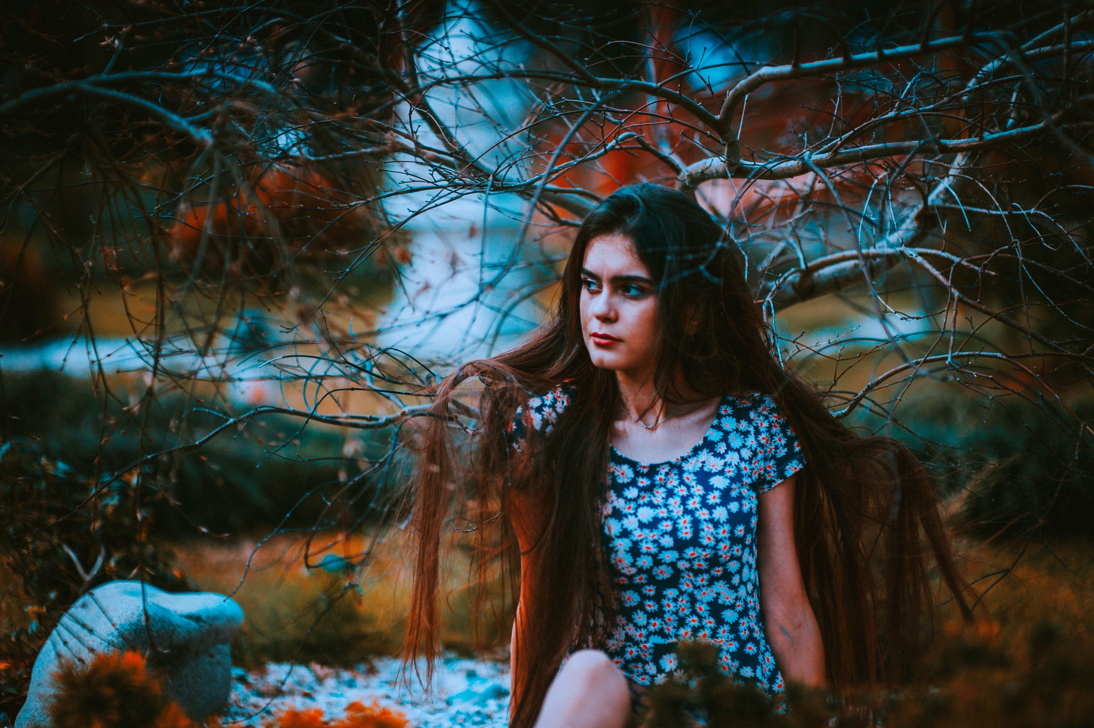 woman sitting near tree